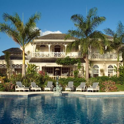 swimming pool with chairs and surrounding trees