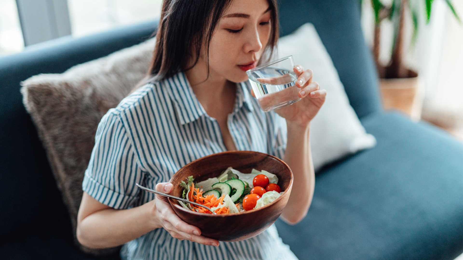 Image of woman eating a healthy meal and drinking water