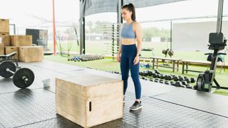 A young woman preparing to do a box jump