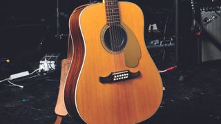 A Fender Villager 12-string acoustic guitar on a stage
