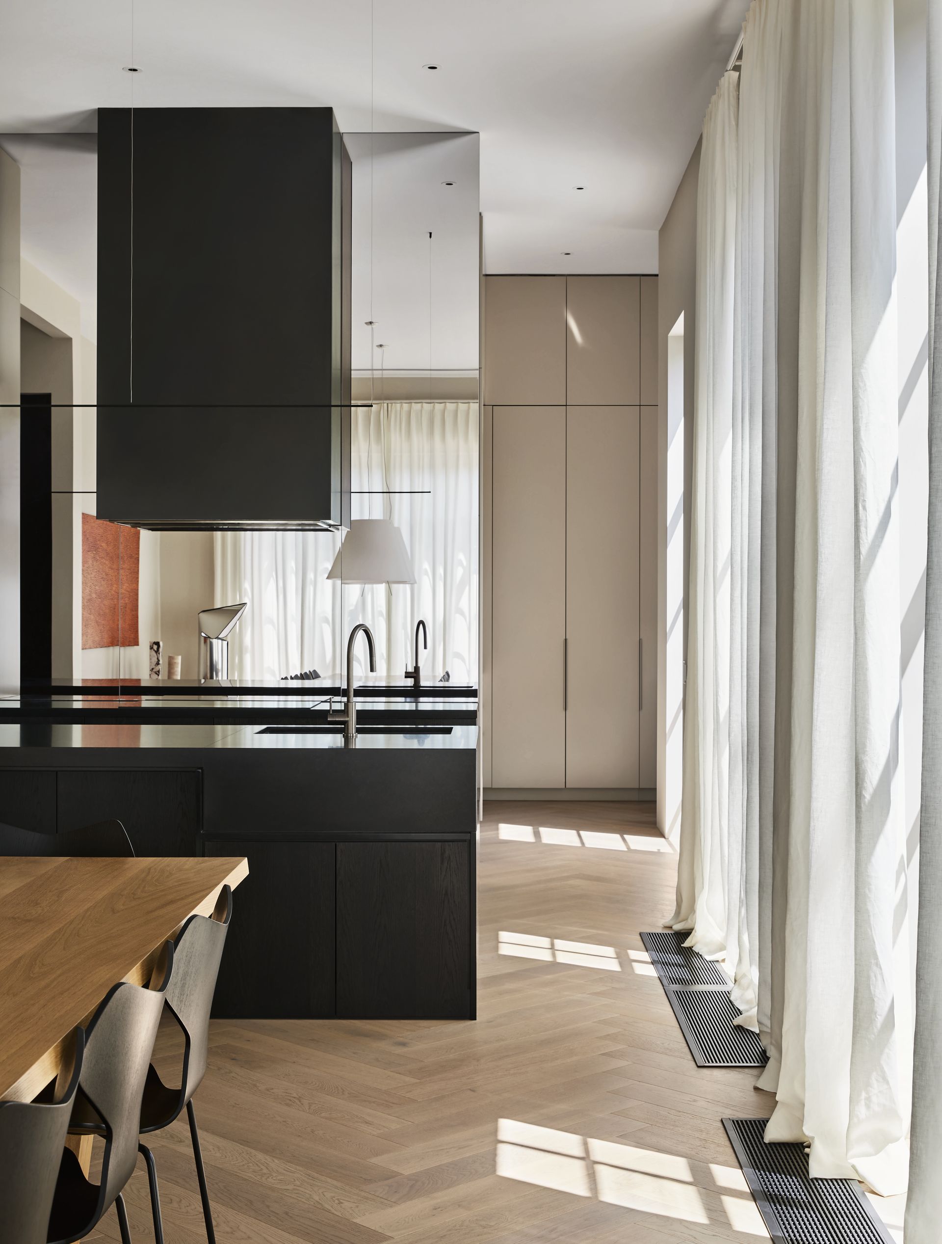 Μια κουζίνα με μακριές κουρτίνες κατά μήκος του παραθύρου