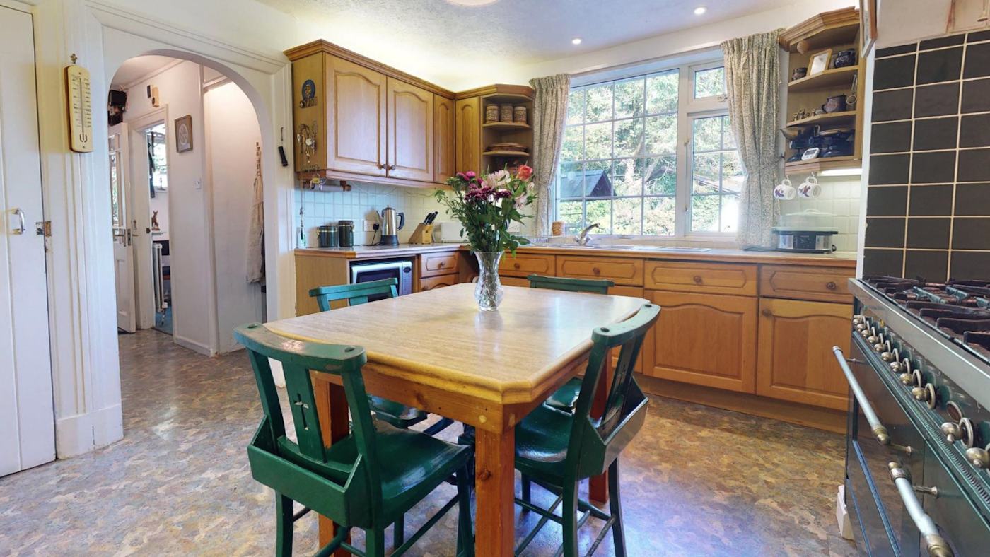 Small kitchen with green chairs