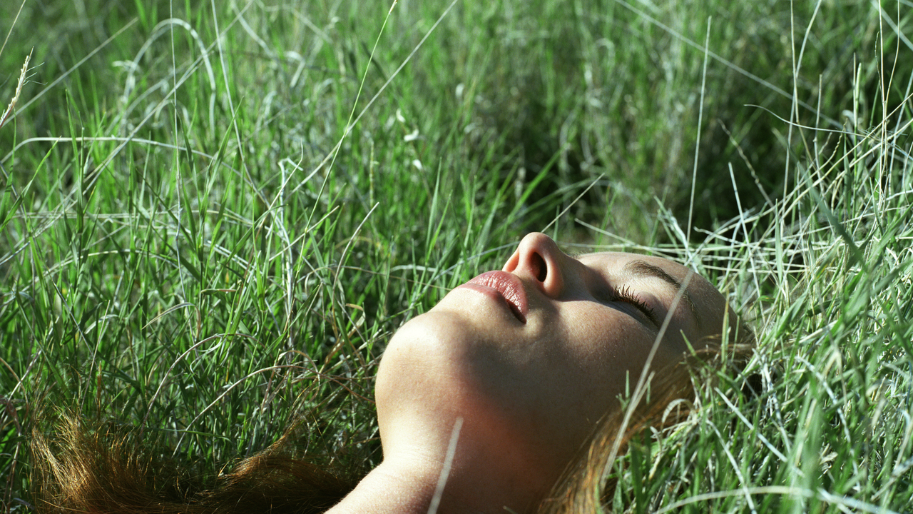 A woman lying in the grass 