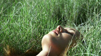 A woman lying in the grass