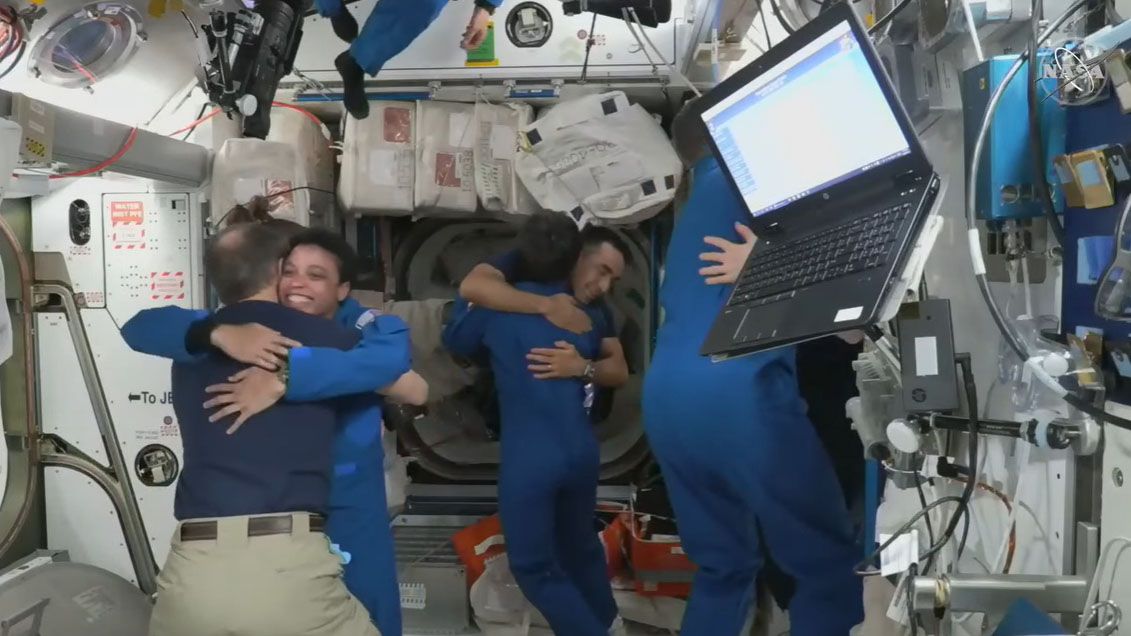 The four astronauts of SpaceX&#039;s Crew-4 mission for NASA share warm hugs and big smiles with their Crew-3 counterparts after entering the International Space Station on April 27, 2022.