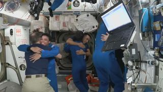 The four astronauts of SpaceX's Crew-4 mission for NASA share warm hugs and big smiles with their Crew-3 counterparts after entering the International Space Station on April 27, 2022.