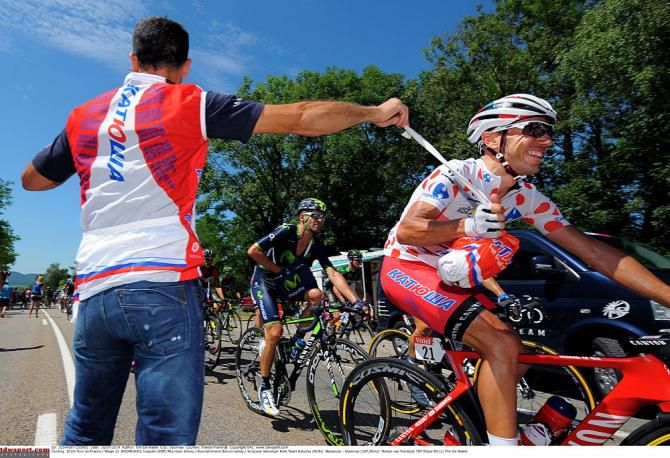 Riding in the polka dot mountains jersey, Joaquim Rodriguez grabs lunch during stage 11.