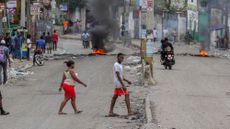 People walk through the streets following unrest in Port-au-Prince, Haiti, on April 16, 2025. 