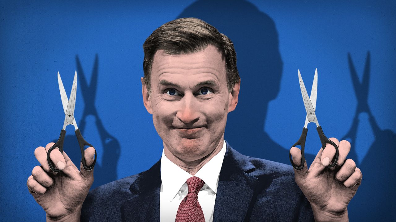 Jeremy Hunt wielding scissors