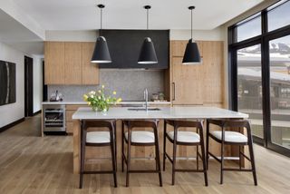 A kitchen with black lights and wooden cabients