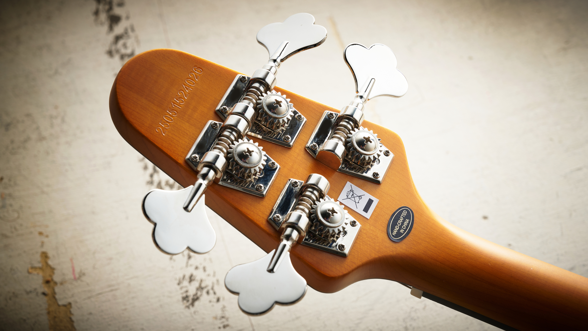 Epiphone Mike Dirnt Grabber G-3 in Silverburst finish photographed on scratched white board.