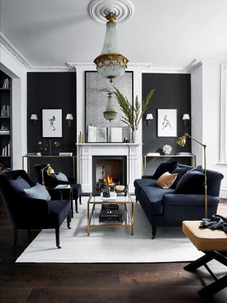 grand living room with black painted walls, black sofas and a white rug