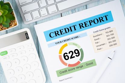 Credit report and calculator with computer keyboard on the desk. 