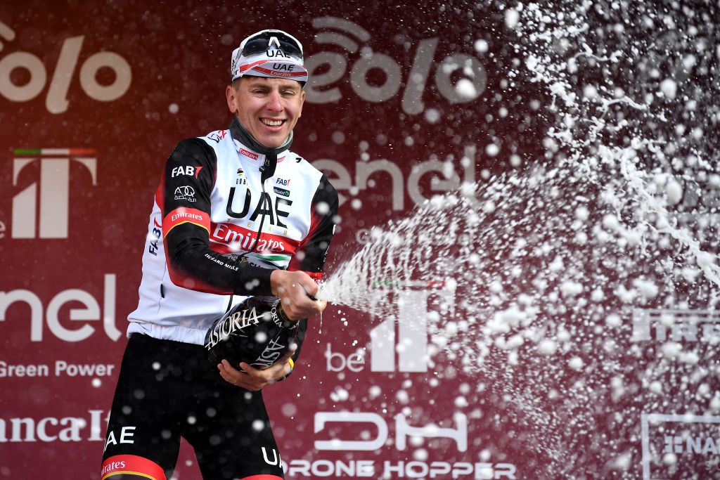 SIENA ITALY MARCH 05 Tadej Pogacar of Slovenia and UAE Team Emirates celebrates with champagne at podium as race winner after the Eroica 16th Strade Bianche 2022 Mens Elite a 184km one day race from Siena to Siena Piazza del Campo 321m StradeBianche WorldTour on March 05 2022 in Siena Italy Photo by Tim de WaeleGetty Images