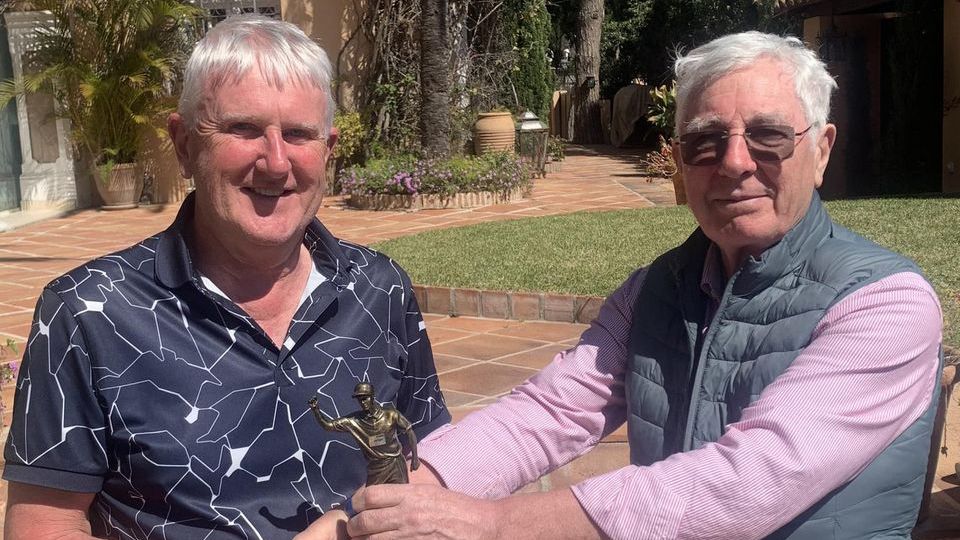 John Murphy (left) is presented with the Doyler Trophy by Cyril Mulligan