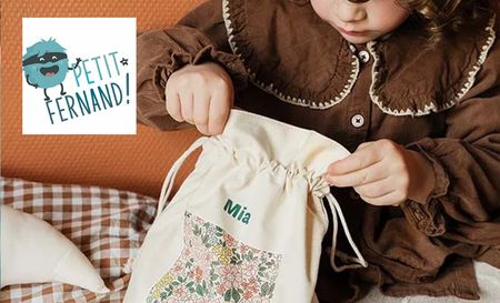 Little girl looking into her petite fernand bag