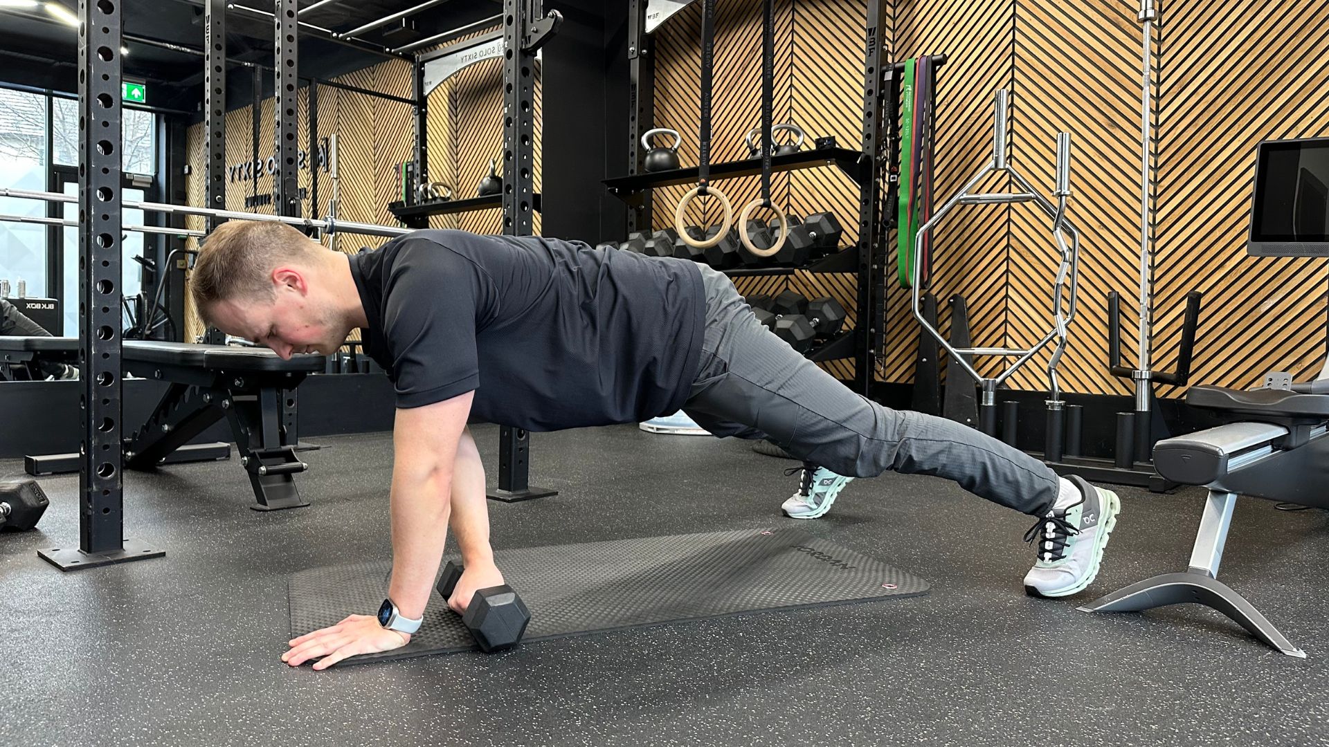 Ollie Thompson demonstrates the plank drag with dumbbell