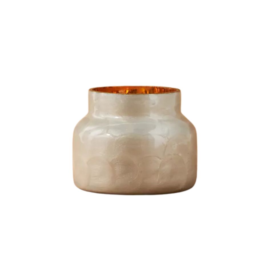 A golden candle with citrus scent