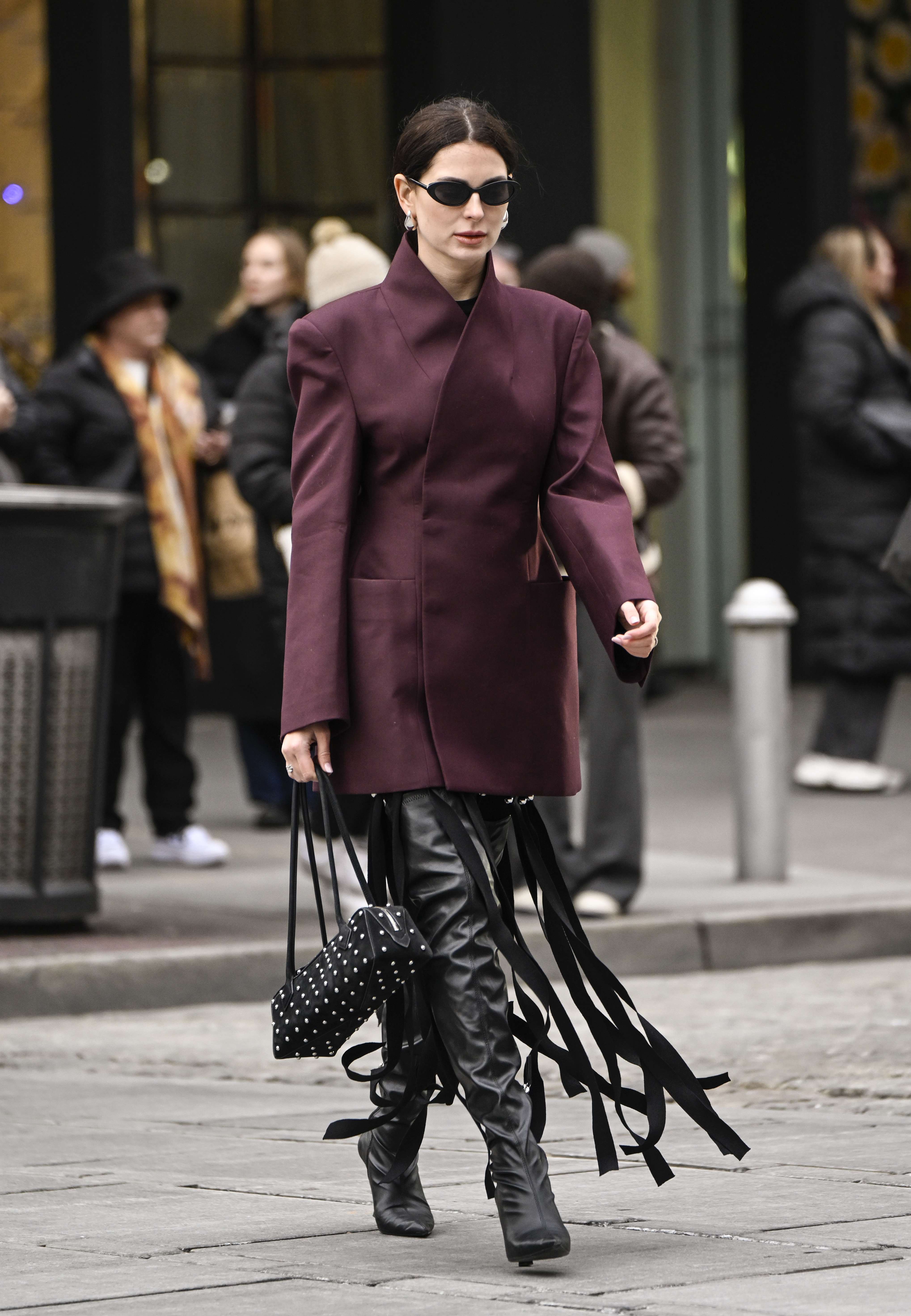 An image of an attended at NYFW wearing the studded bag trend.