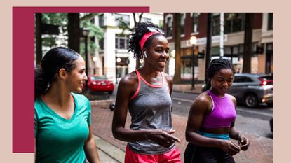 Three women laughing and walking together wearing workout clothes, trying out LISS cardio in the city