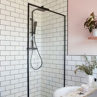 bathroom with white tiles and shower frame
