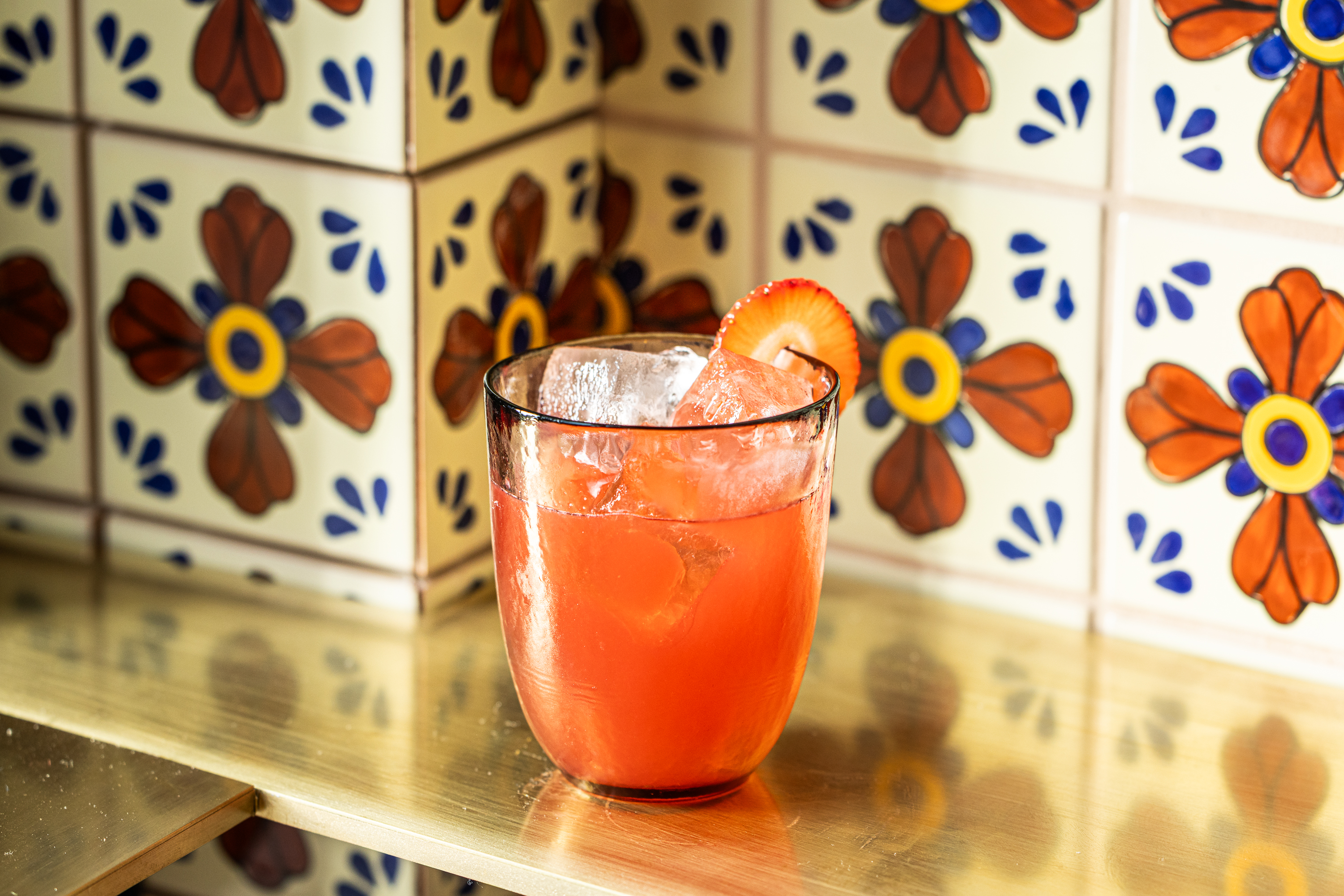 Mixteca branding featuring a pink cocktail against a floral tiled background