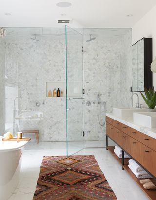 white bathroom with double shower and morroccan rug