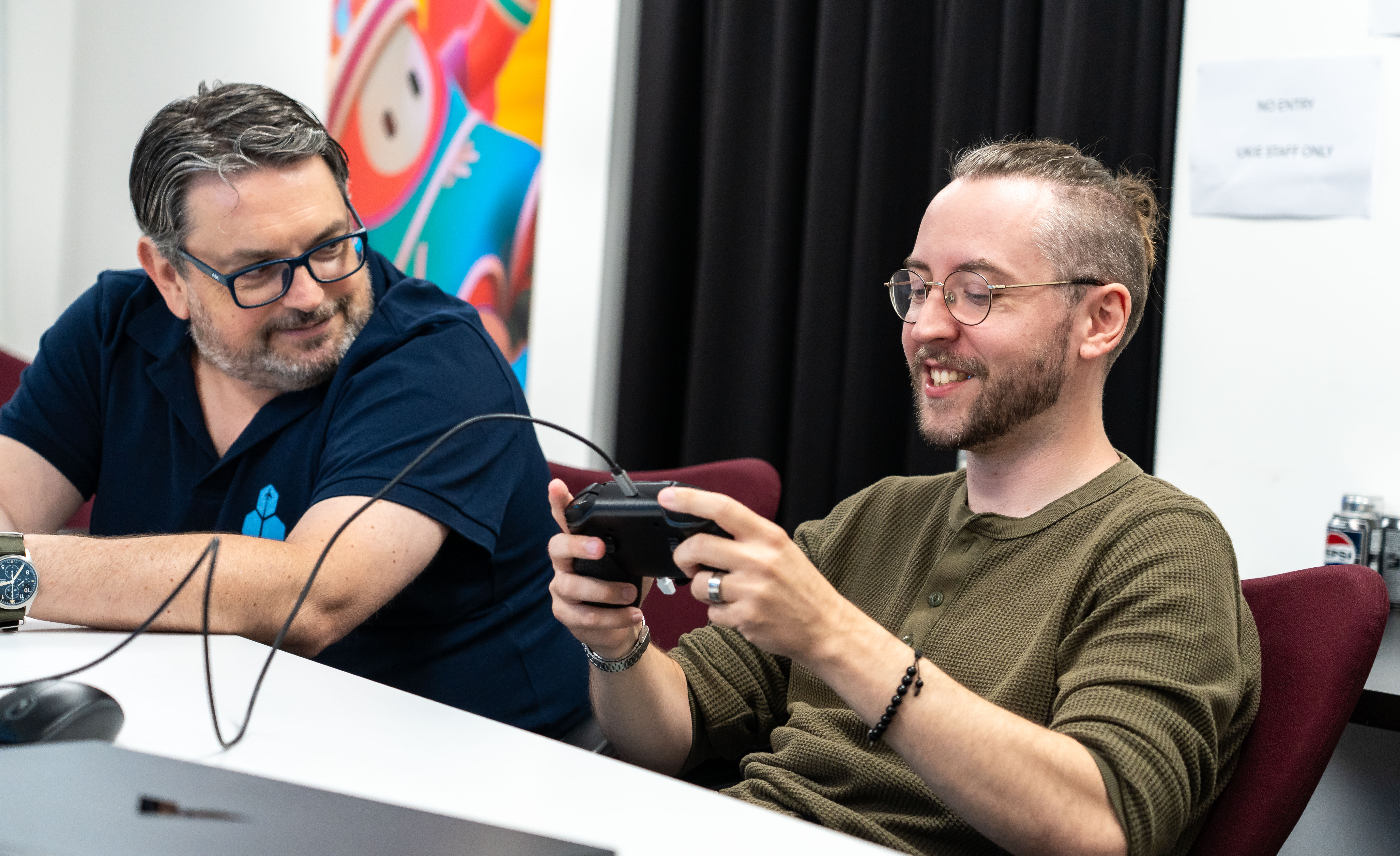 snakebyte | GROUP CTO Marc Küpper (left) watches as Windows Central Senior Editor Ben Wilson (right) uses a Honeycomb Aeronautical Echo Avitaion Controller prototype.