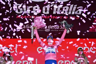 MADONNA DI CAMPIGLIO ITALY OCTOBER 21 Podium Joao Almeida of Portugal and Team Deceuninck QuickStep Pink Leader Jersey Celebration Flowers Miss Hostess during the 103rd Giro dItalia 2020 Stage 17 a 203km stage from Bassano del Grappa to Madonna di Campiglio 1514m girodiitalia Giro on October 21 2020 in Madonna di Campiglio Italy Photo by Tim de WaeleGetty Images