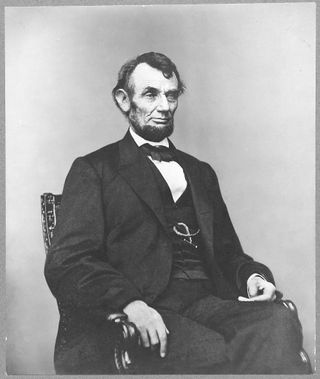 [Abraham Lincoln, three-quarter length portrait, seated, facing right; hair parted on Lincoln's right side]