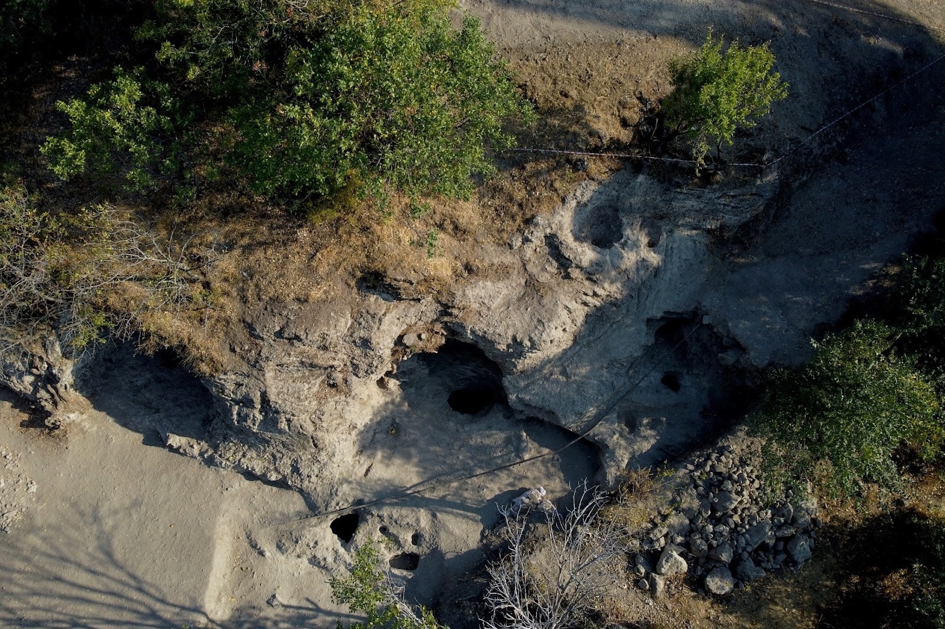 An aerial photo of a primitive carved sanctuary in a stone hill