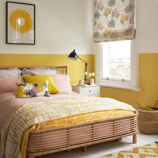 Yellow and white bedroom with lots of yellow accents, including yellow bedding and rug