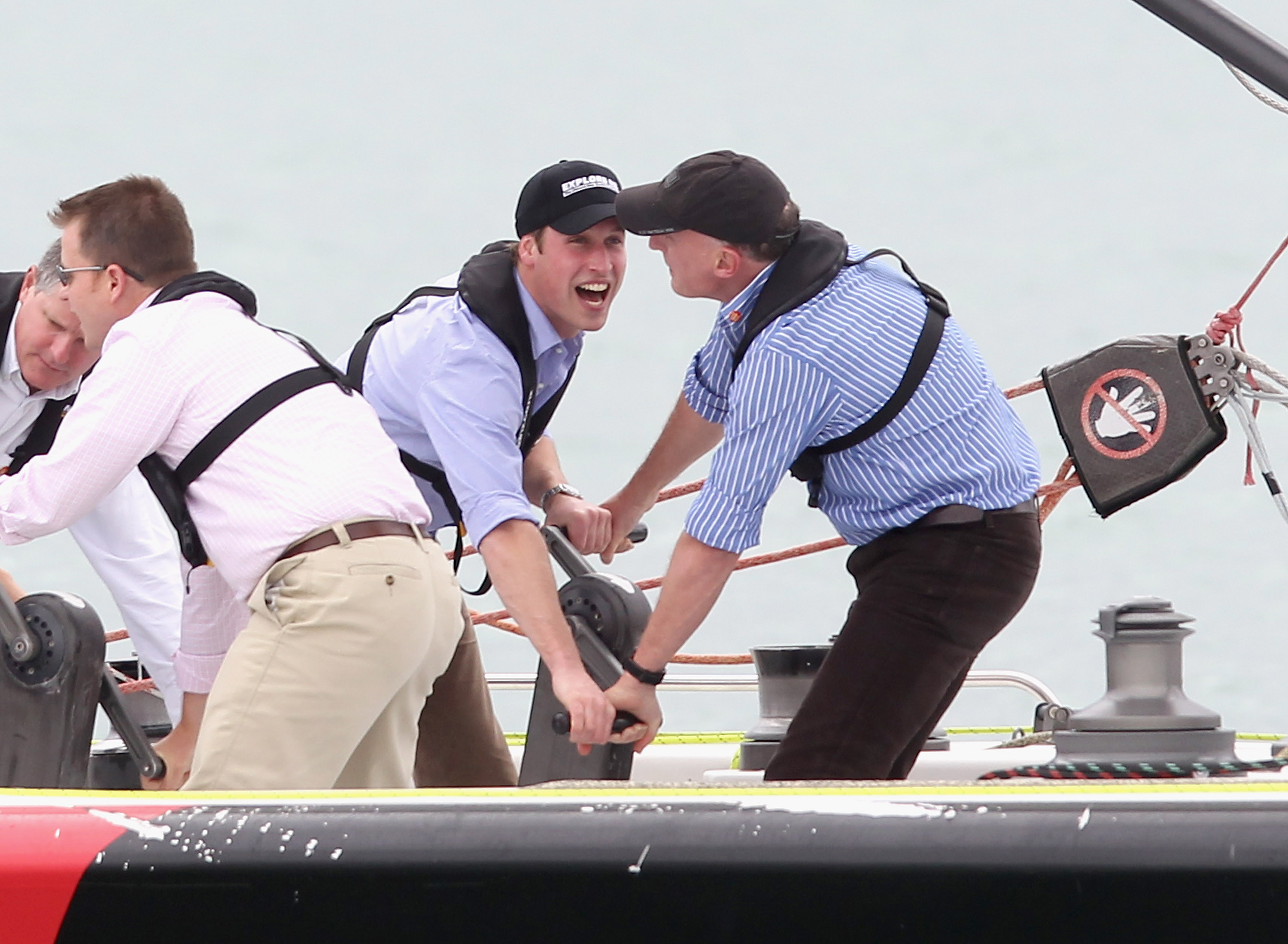 Prince William and Jamie Lowther-Pinkerton sailing a boat