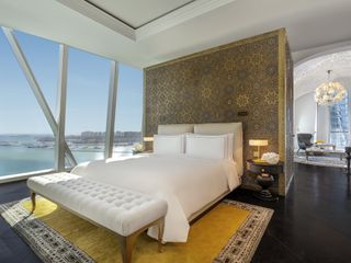 A bedroom at Raffles Doha with a view of the city