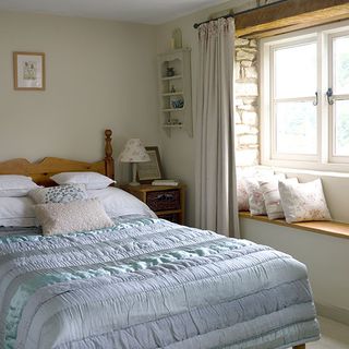 bedroom with double bed and window sill with cushions