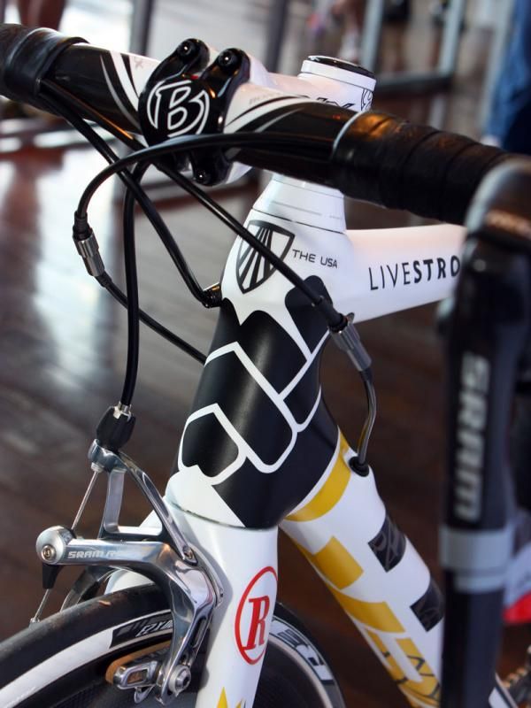 Two clenched fists come together at the front of the head tube.