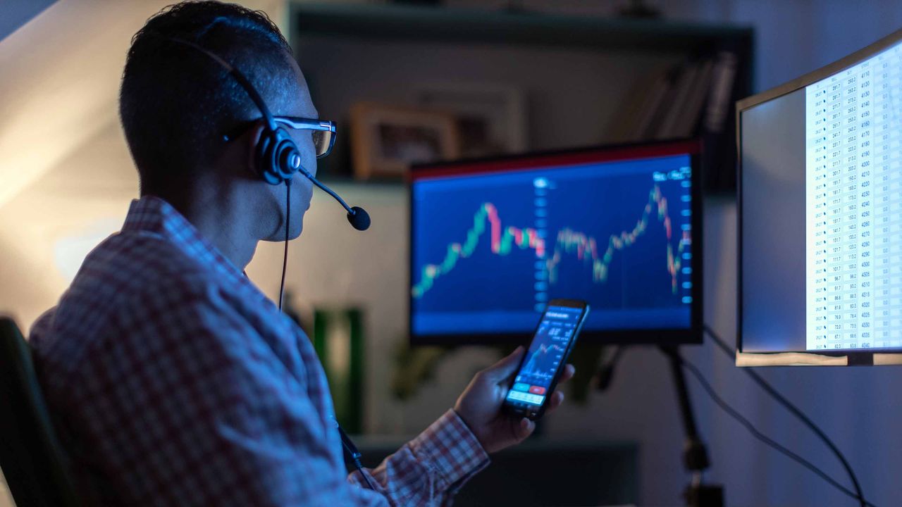 What&#039;s next for stocks? An investor looks at stock charts on phone and computer.