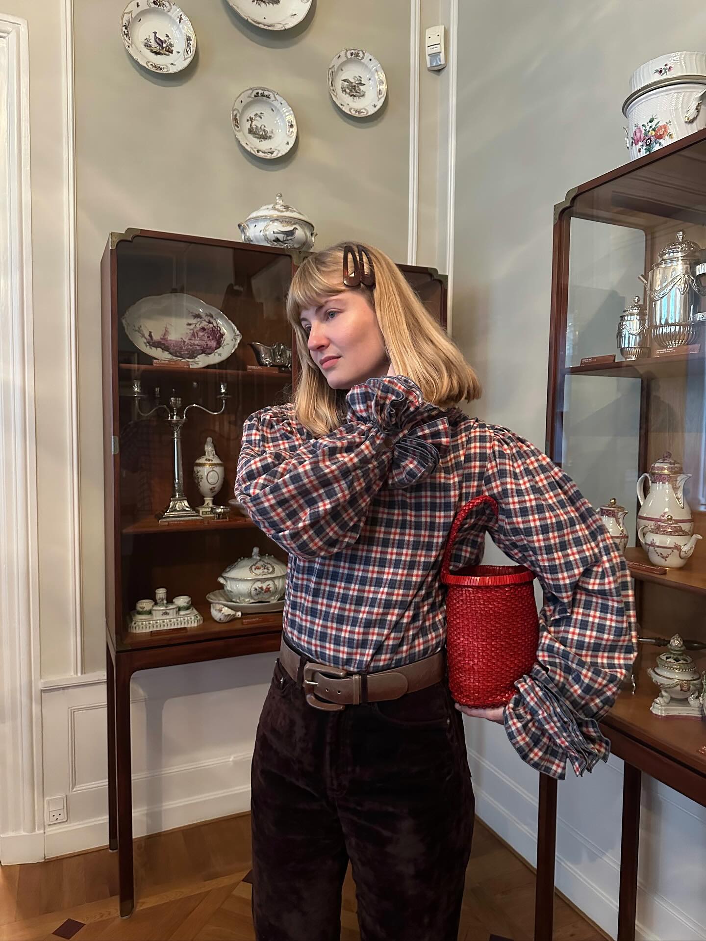 anne johannsen wears a check blouse and black trousers