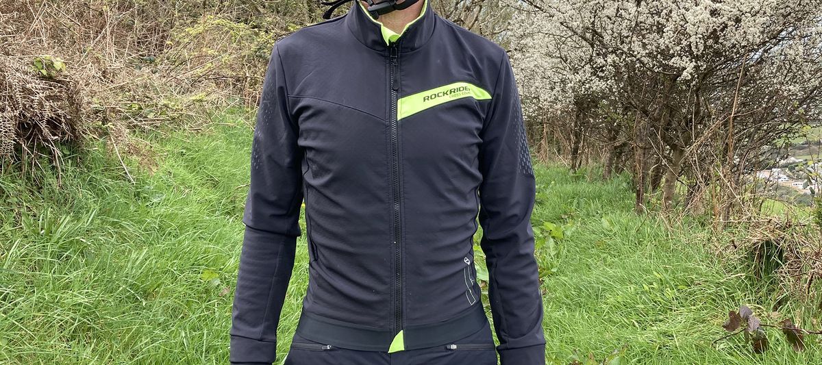 Mountain biker wearing Rockrider Slim-Fit Softshell Mountain Biking Jacket