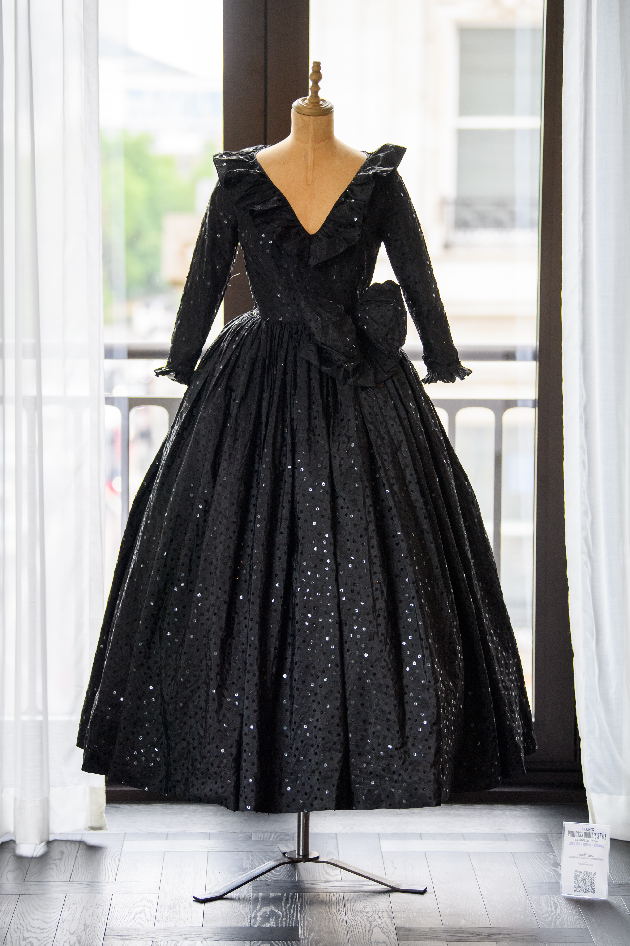 A black sequin dress on a mannequin at a Princess Diana auction