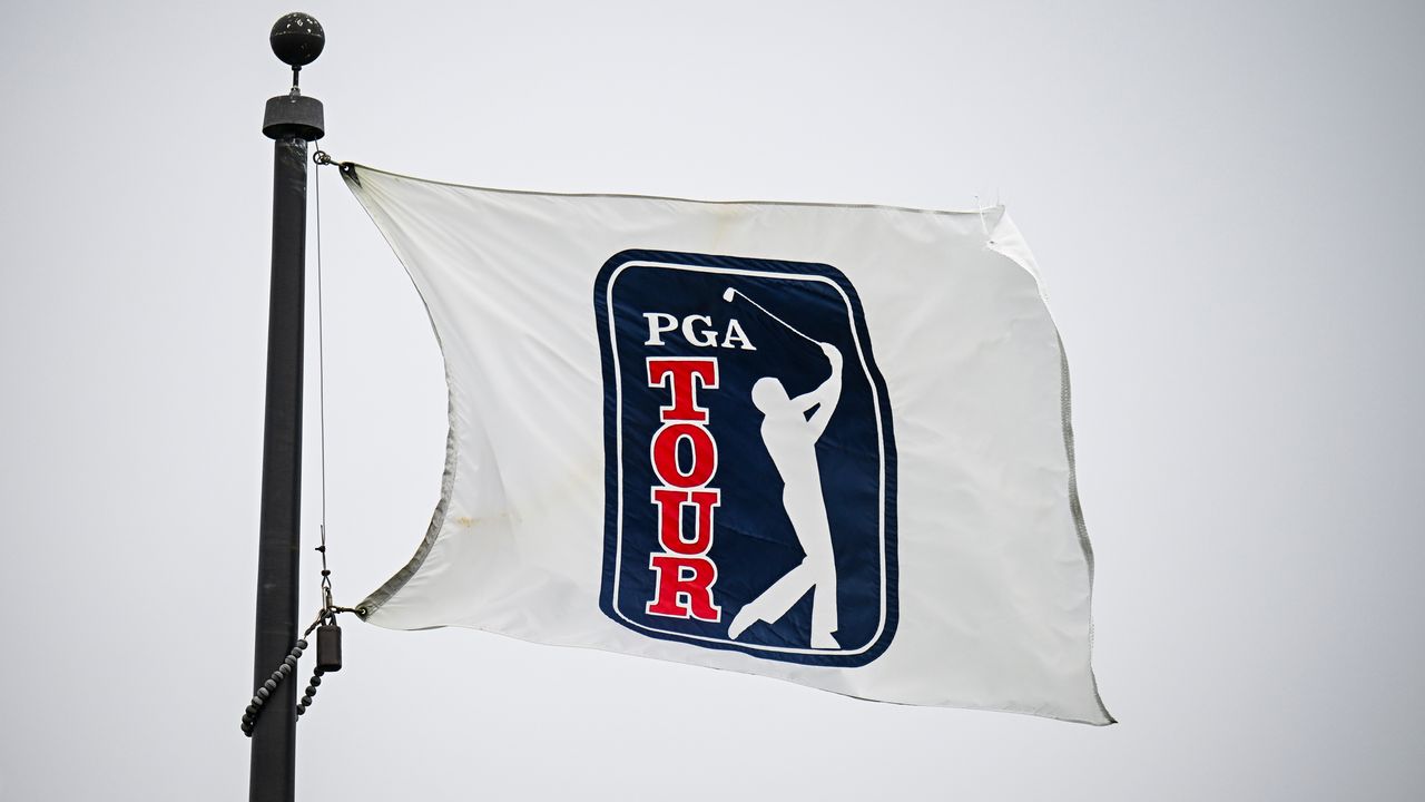 A white PGA Tour flag blows in the wind