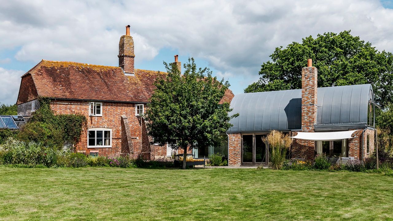 house exterior with bricked wall and trees