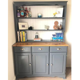 painted dresser with wooden flooring and shelves