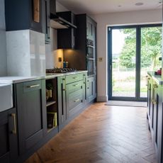 kitchen with blue cabinetry and bi-fold doors