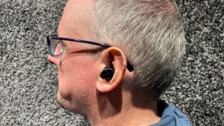 Bowers Wilkins Pi8 earbuds in someone's left ear