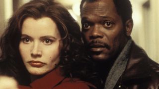 Samuel L. Jackson stands with Geena Davis in a hallway in The Long Kiss Goodnight
