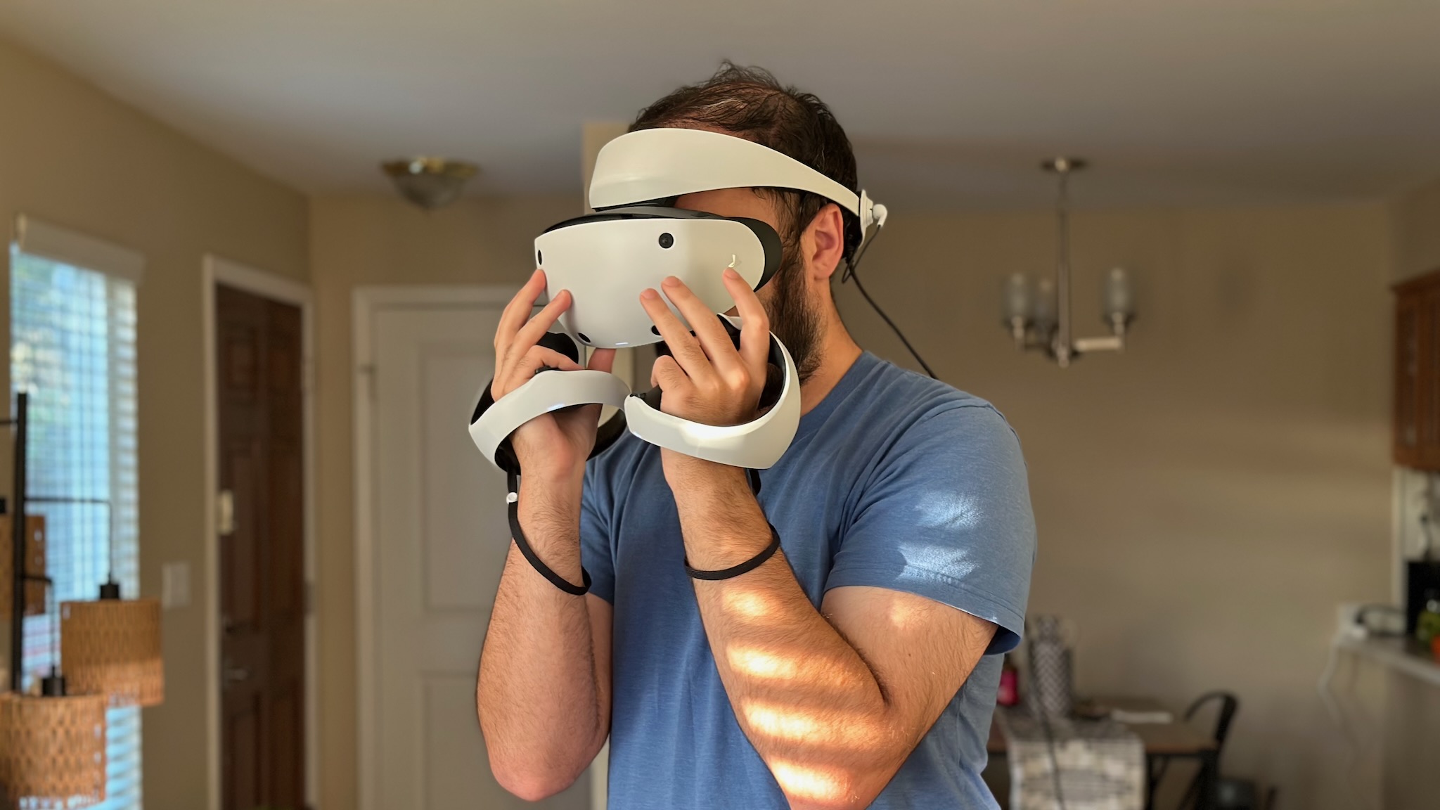 The author putting on the Sony PS VR2 headset.