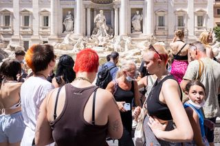 People standing in front of the Trevi Fountain in Rome