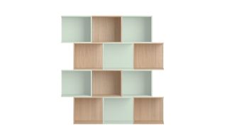 Shelving design by Nando. Pale mind green and light brown natural wood boxes are stacked one next and on top of each other.