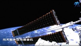 The solar array of China's Wentian module on the Tiangong space station unfurled over the blue Earth.